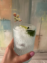 Load image into Gallery viewer, acrylic drink stir of baby holding banana in glass cup