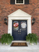 Load image into Gallery viewer, Football Door Hanger with Saints Shirld on a Brick house
