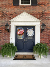 Load image into Gallery viewer, Football Door Hanger with Saints Shirld on a Brick house